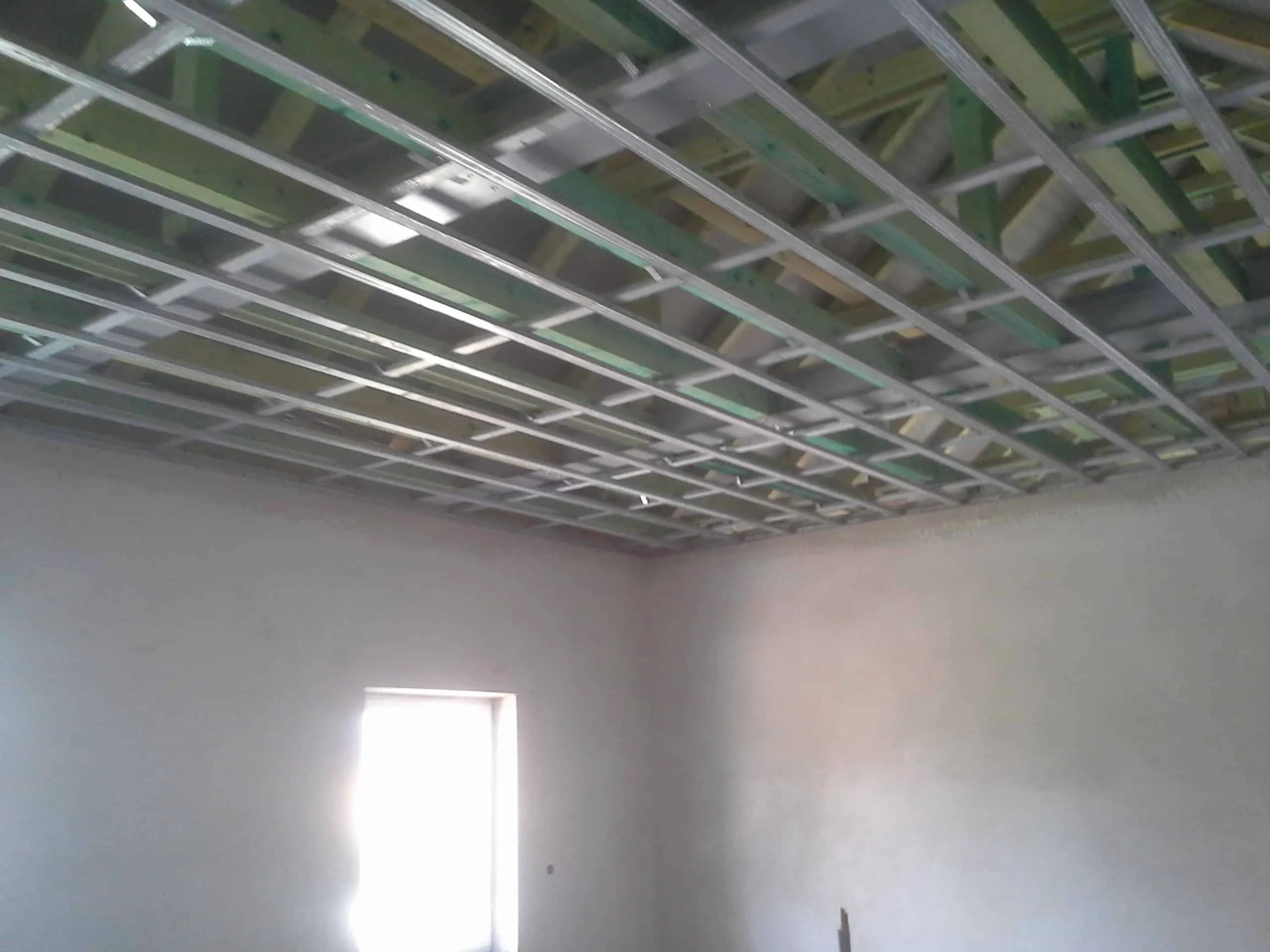 Odpružená kovová konstrukce závěsného stropu určená pro zvukovou izolaci proti hluku shora